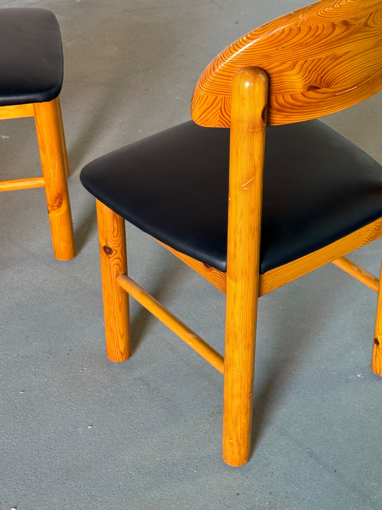 Wooden Daumiller chairs with black leather seats