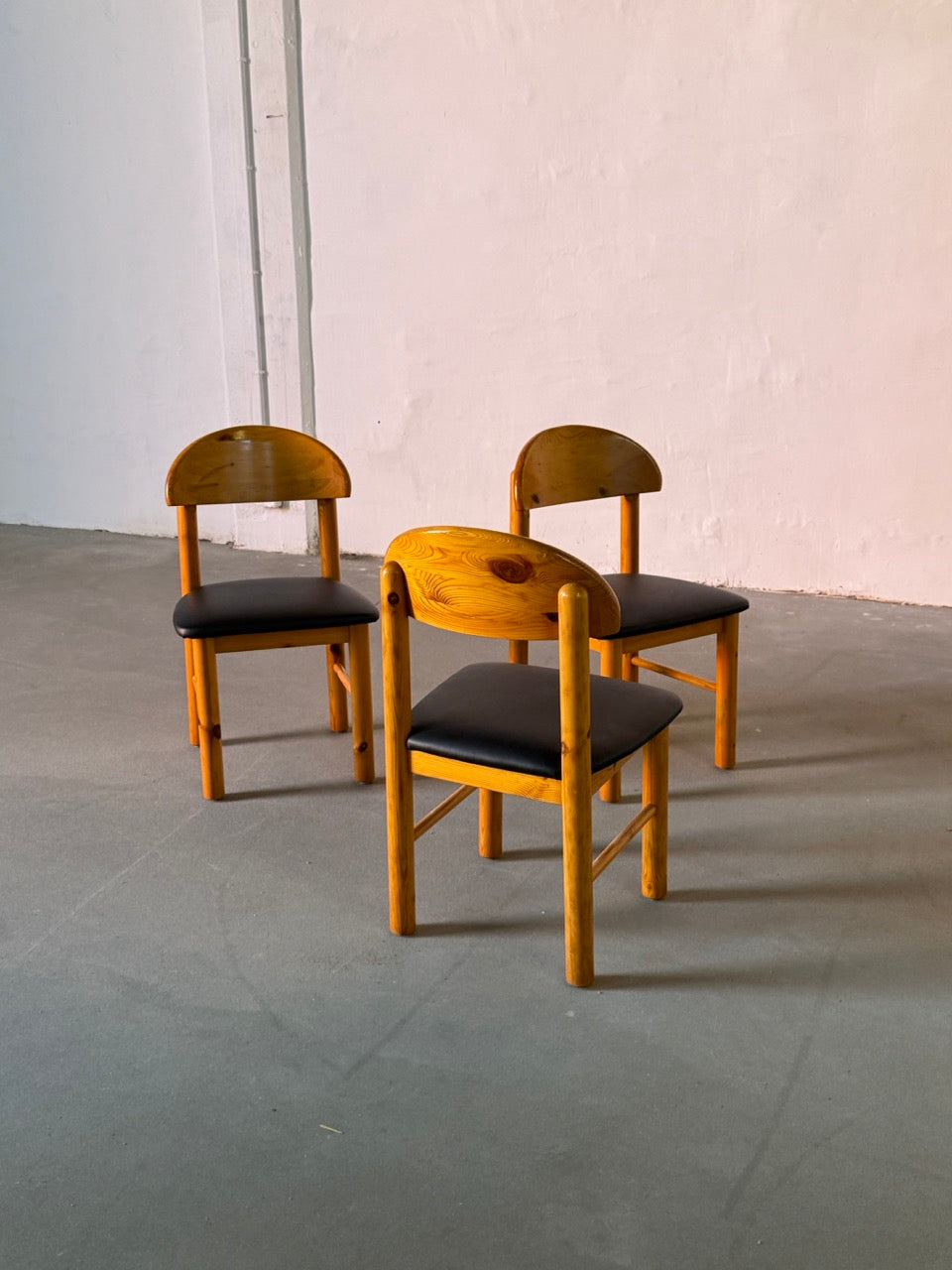 Wooden Daumiller chairs with black leather seats